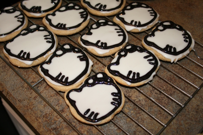 I bought black gel icing and used that to out line the head, the bow (which consisted of 2 big circles and a small one in the middle) and the whiskers. This is what took so long. When I do the rest of the cookies I'm going to cut the tube so the opening isn't so big.